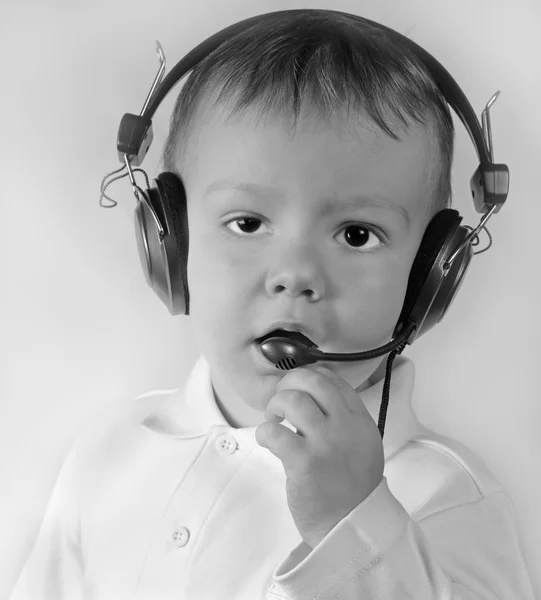 Business kid in telephone ear-phones — Stock Photo, Image