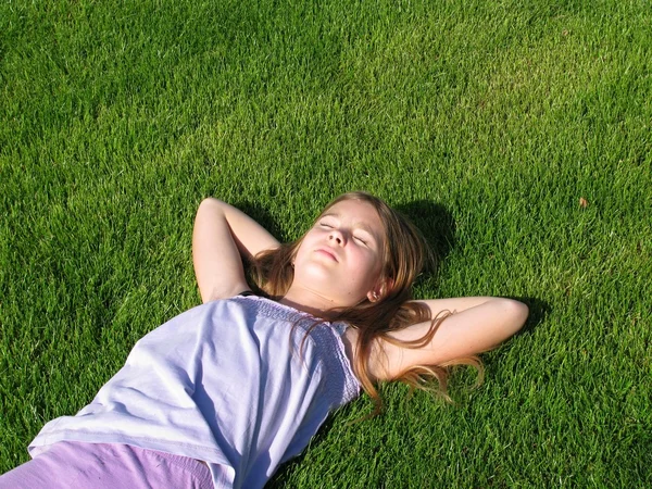 stock image Young girl lying on grass