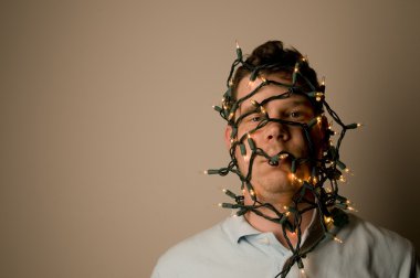 Man wrapped in Christmas lights clipart