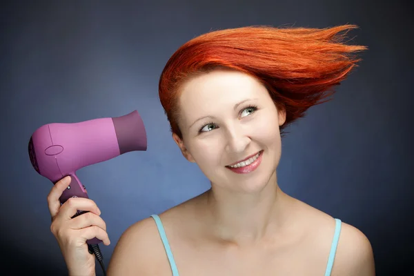 Redhead woman drying her hair — Stock Photo, Image