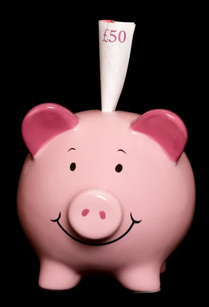 Piggybank med femtio pund anteckning — Stockfoto