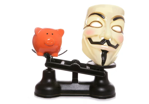 Guy fawkes masker met piggy bank — Stockfoto