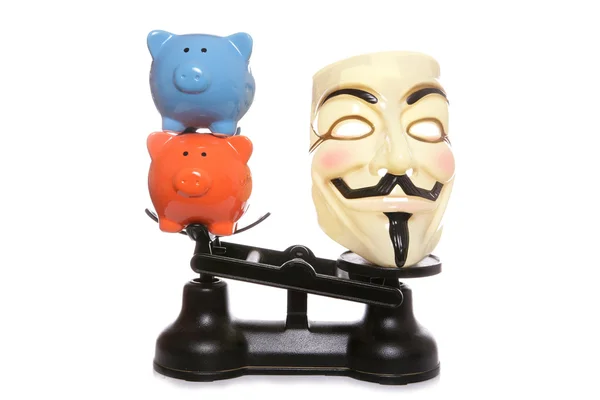 Guy fawkes mask with two piggy banks — Stock Photo, Image