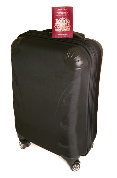 Négy kerekes bőrönd, a passport — Stock Fotó