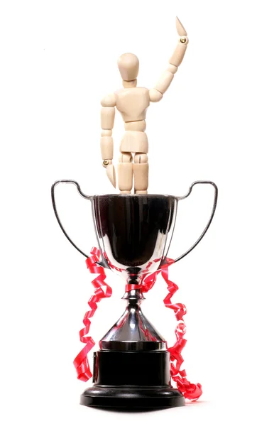 Artist mannequin celebrating winning in a trophy — Stock Photo, Image