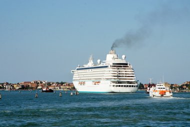 Giant ocean liner is transported out of the port of Venice clipart