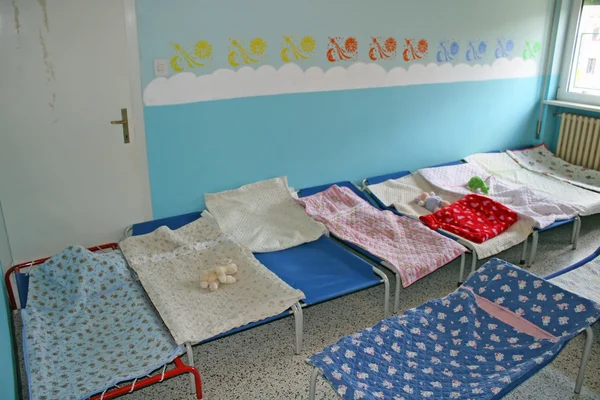 stock image Dormitory for children with small beds and blankets for a kindergarten