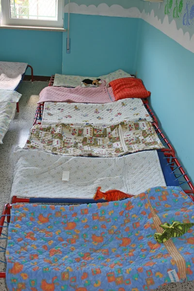 stock image Dormitory for children with small beds and blankets for a kindergarten