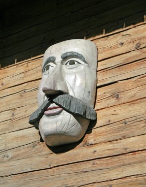 Wooden mask with a face with big whiskers clipart