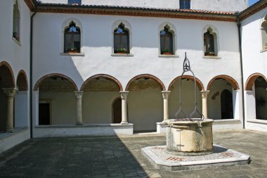 Cloister of the convent with the ancient well clipart
