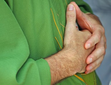 Hands clasped in prayer the priest with dress clipart