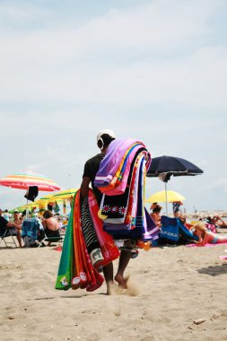 Hawker beach towels on the beach in the sand clipart