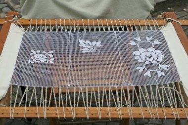 Weaving loom and embroidery on centrepieces for precious clipart