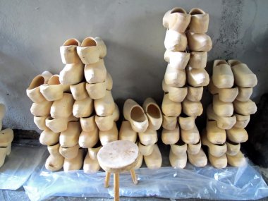 Wooden clogs for sale at the market of shoes clipart