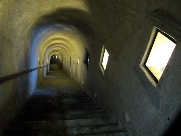 Tunnel door trappen die Abstieg in duisternis — Stockfoto