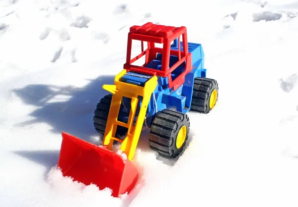 Child's toy scraper in use on fresh snow white — Stock Photo, Image