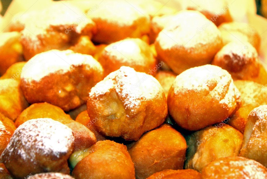 Carnival fritters with vanilla cream and raisins for sale in pastry