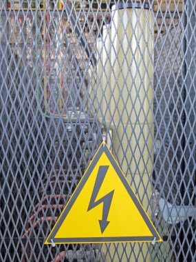 Sign of danger inside of a power plant for the production of energy clipart