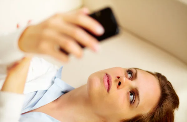 Młoda kobieta w domu przy użyciu telefon — Zdjęcie stockowe