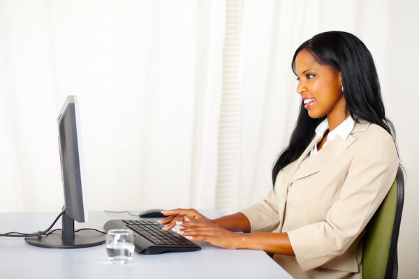 Friendly businesswoman working on computer