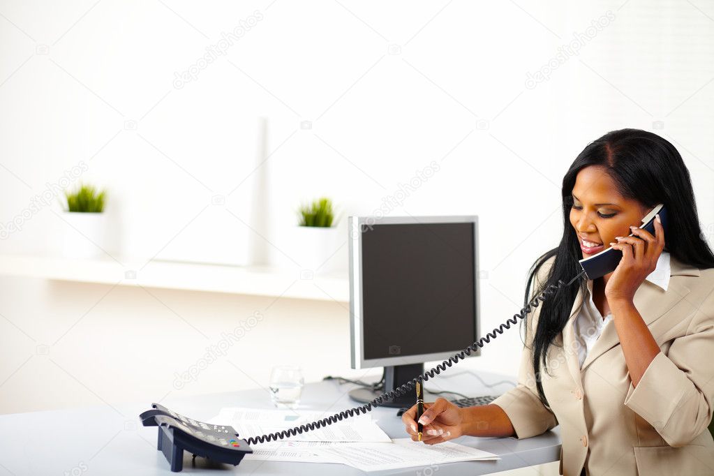 Businesswoman on phone while working