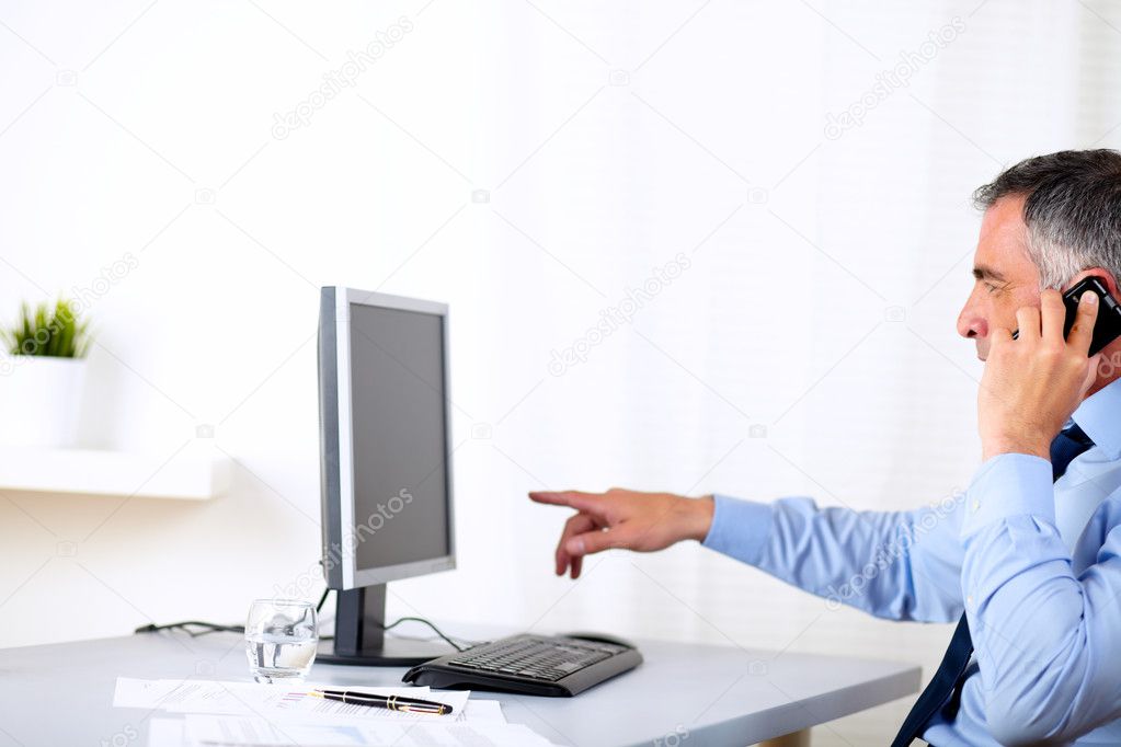 Elegant business man pointing the computer