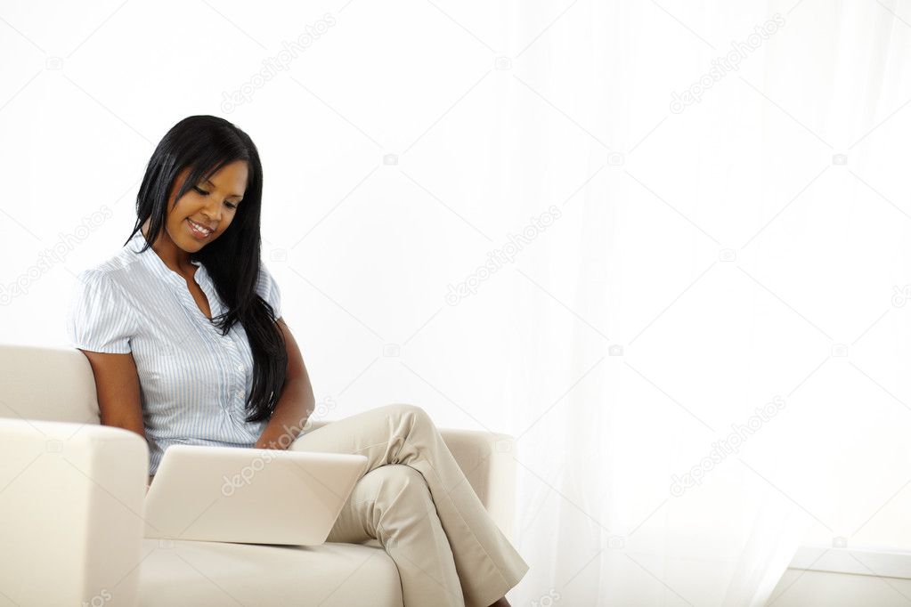 Black young woman browsing on laptop