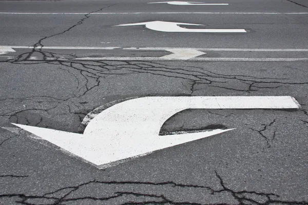 Arrows with cracked asphalt texture — Stock Photo, Image