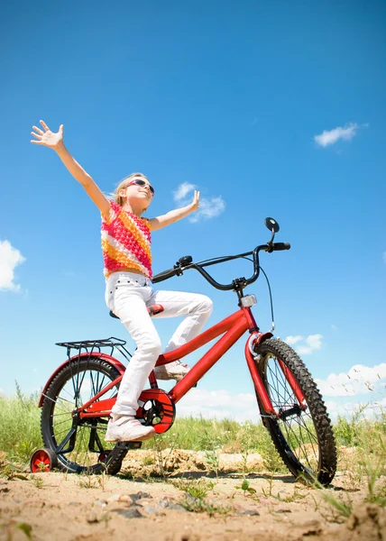 Girl on red bicycle — Stock Photo, Image