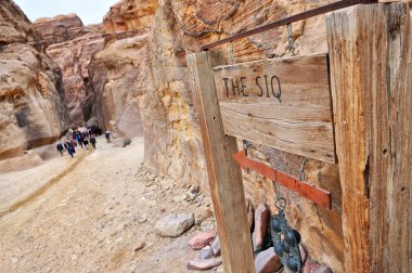 The Siq sign and entrance, the narrow slot-canyon, the entrance passage to clipart