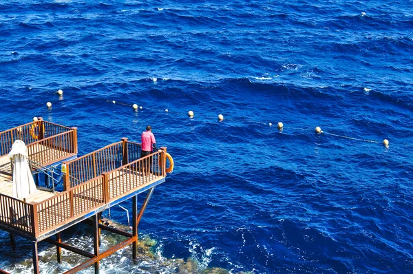 stock image Life guard on duty in blue ocean