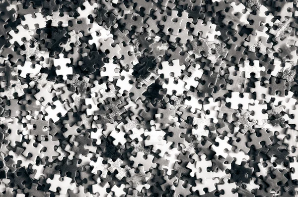Pile of unfinished puzzle black and white — Stock Photo, Image