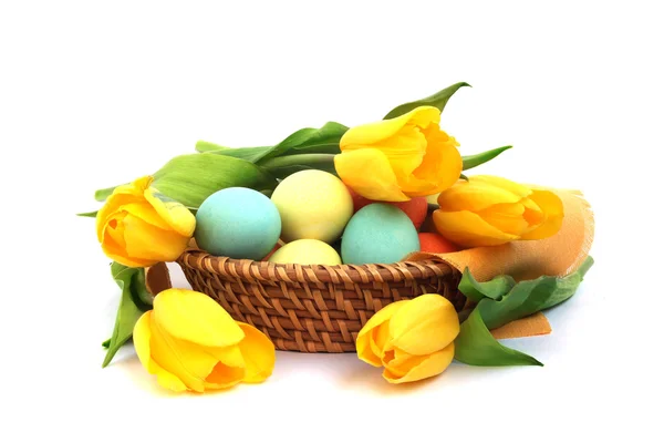 stock image Easter eggs in basket with tulips