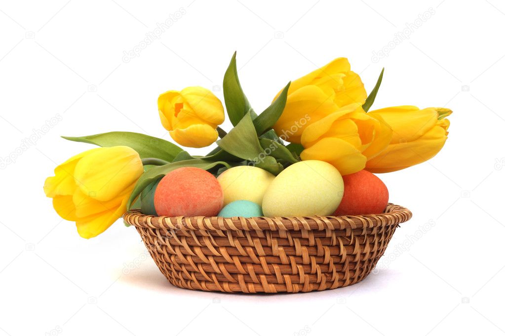Easter eggs in basket with tulips