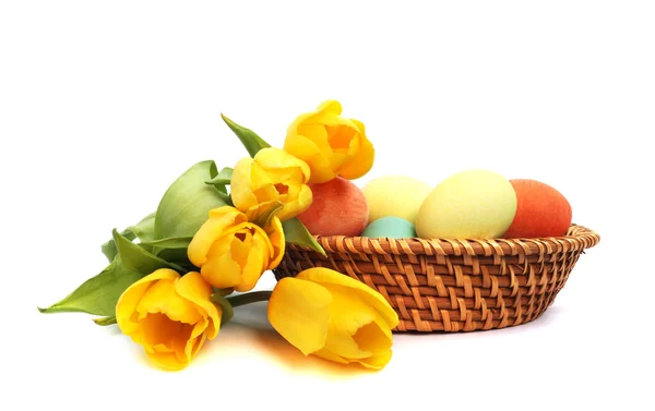 stock image Easter eggs in basket with tulips