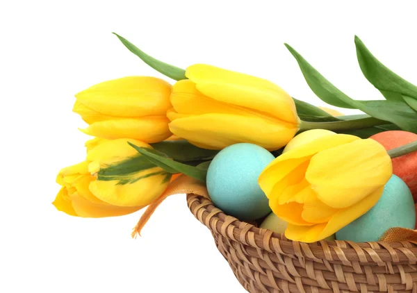Easter eggs in basket with tulips — Stock Photo, Image