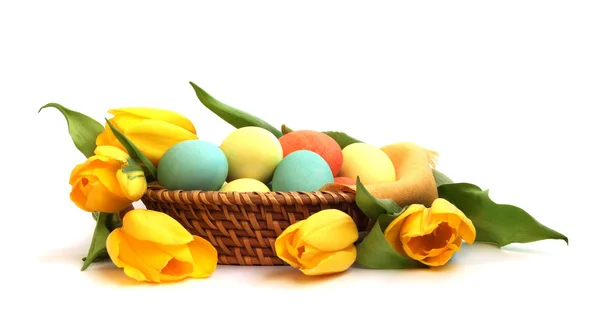 stock image Easter eggs in basket with tulips