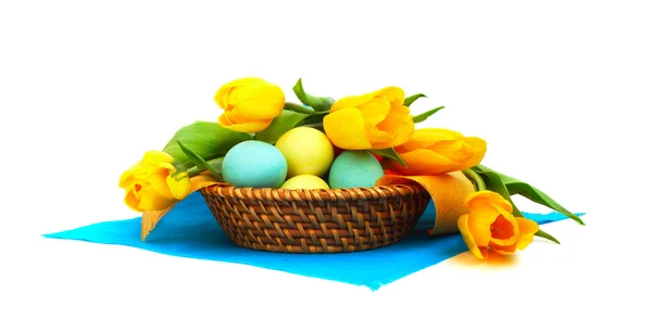 stock image Easter eggs in basket with tulips