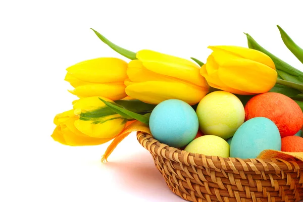 Easter eggs in basket with tulips — Stock Photo, Image