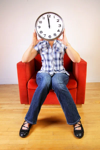 stock image Woman holding a clock