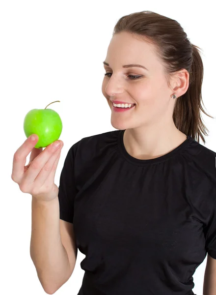 Donna che tiene una mela verde e sorride — Foto Stock