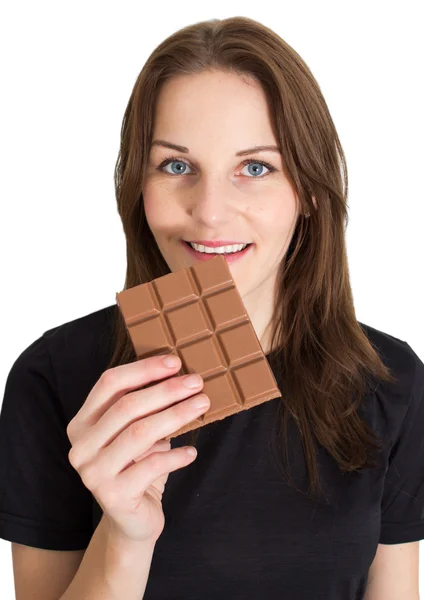 Mujer comiendo chocolate y sonriendo —  Fotos de Stock