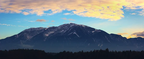 stock image The Austrian alps With Orange Sky And Clouds Above Them