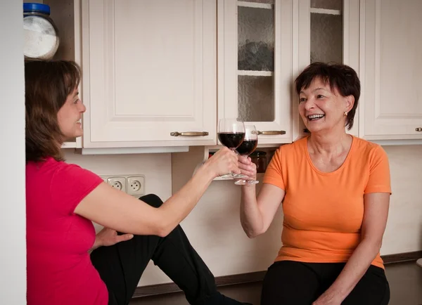Mother and daughter drinking wine