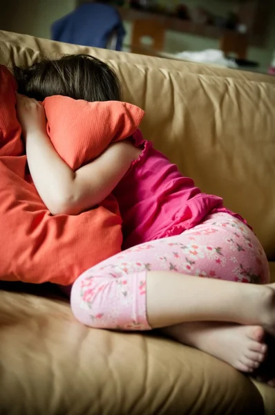 Depressed child covering head with pillow — Stock Photo, Image
