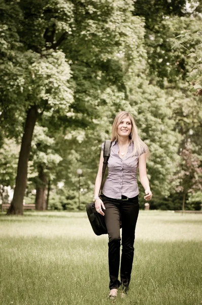 Business woman walking outdoors in park — Stock Photo, Image