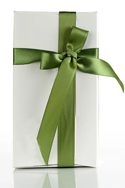 stock image White cardboard box with a green ribbon.