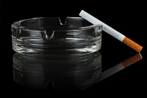 Cigarette and glass ashtray. — Stock Photo, Image