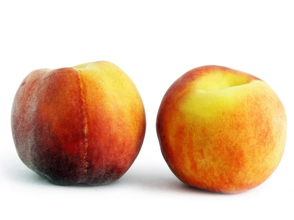 Two peaches on a white background. — Stock Photo, Image