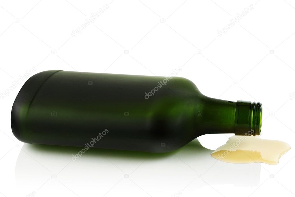 Lying on its side a bottle of liquor from a green glass.